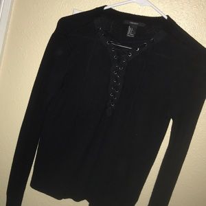 black long sleeve top with open chest strings